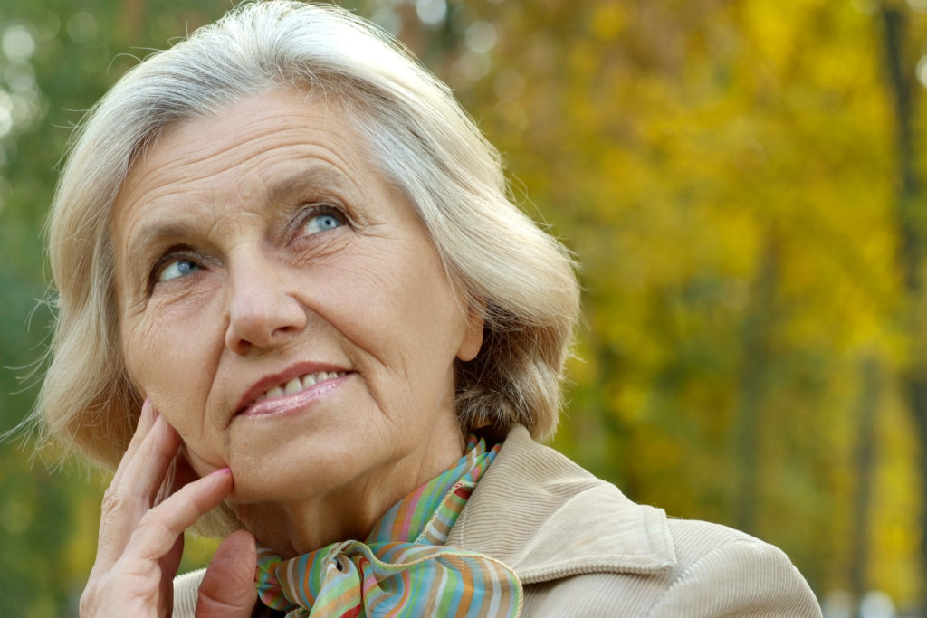Age-related health. Senior woman in autumn park