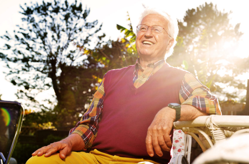 health care costs. Elderly man sitting in yard