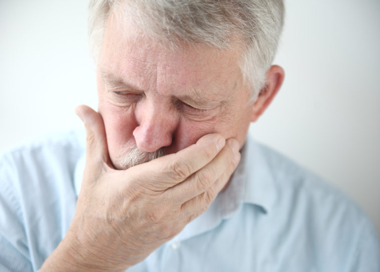 long-term disability insurance. Older man with hand over mouth