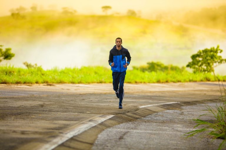 Man running on road. Exercise helps keep brain young.