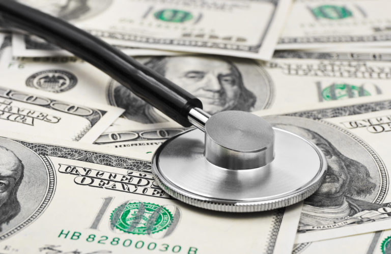 Medicare: stethoscope on top of pile of money