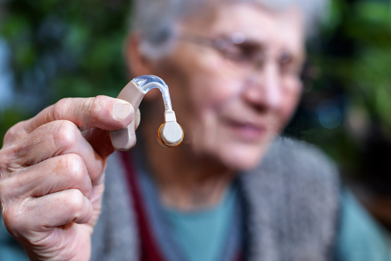 Elderly woman with hearing aid