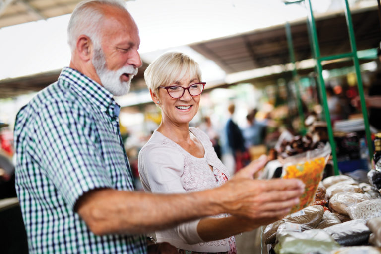 Kitchen tricks. Seniors grocery shopping buying prepared produce to make cooking simpler