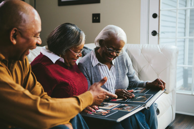 Seniors looking at a photo album. Communication pointers for dementia