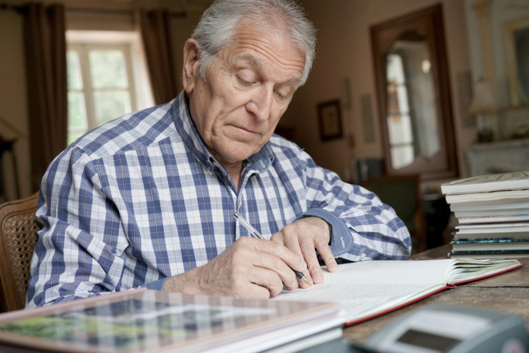 Senior man writing memoirs