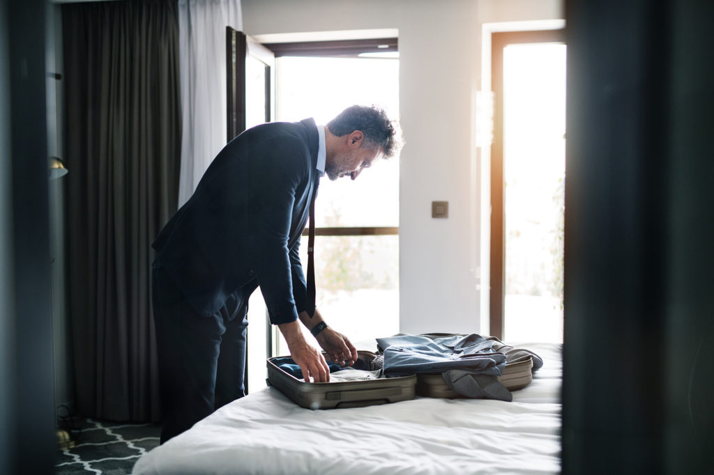 Man packing suitcase for hospital stay