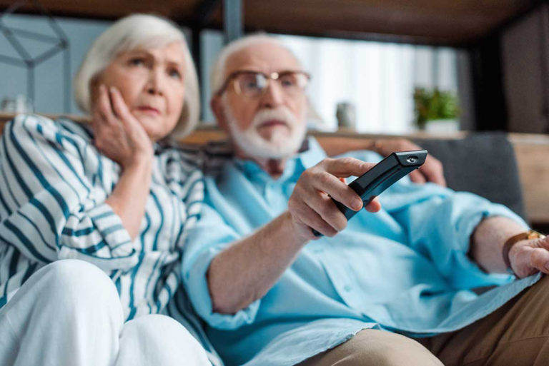 Seniors watching TV with loud volume