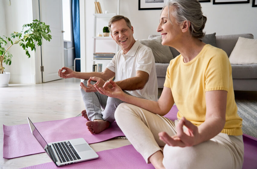 Senior couple doing virtual online yoga class