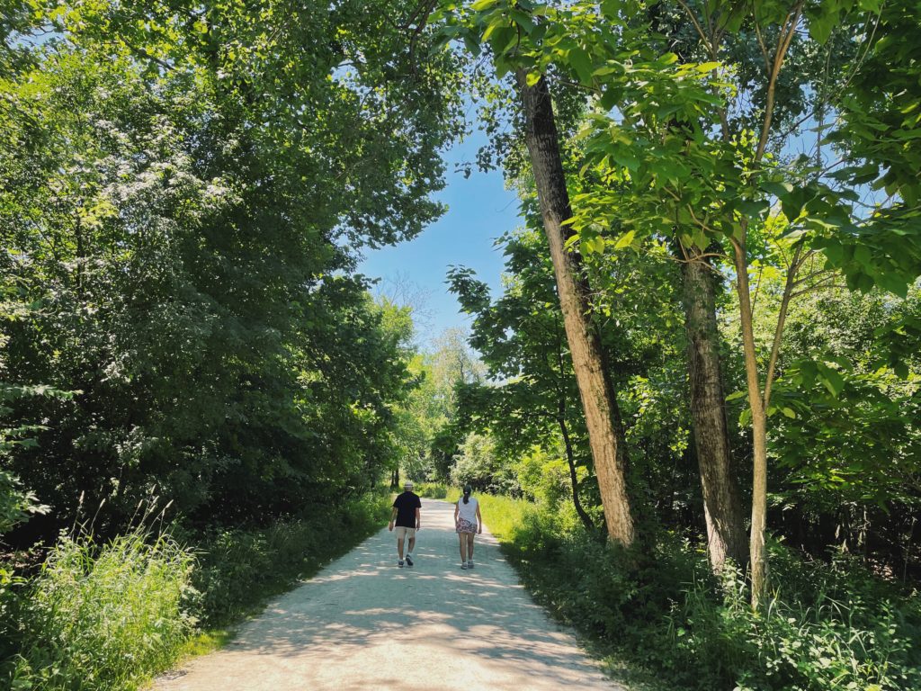 Two people walking down a trail in Fullersburg Woods