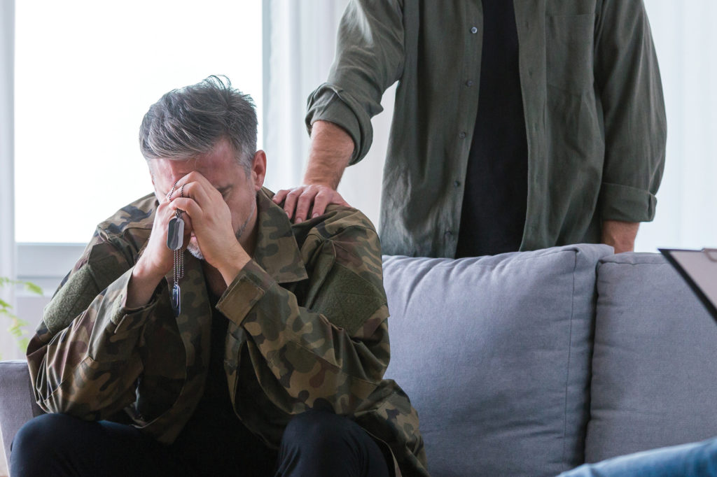 Distressed veteran being comforted. Veterans Resources
