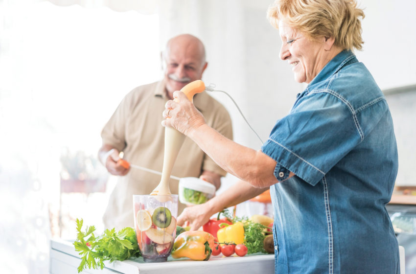 Seniors cooking nutritious food together, important for oral health