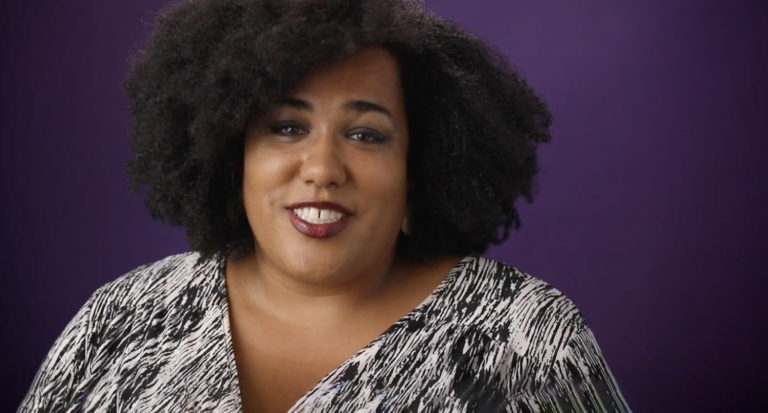 Jacqueline Boyd, The Care Plan founder, smiling at the camera against a purple background.