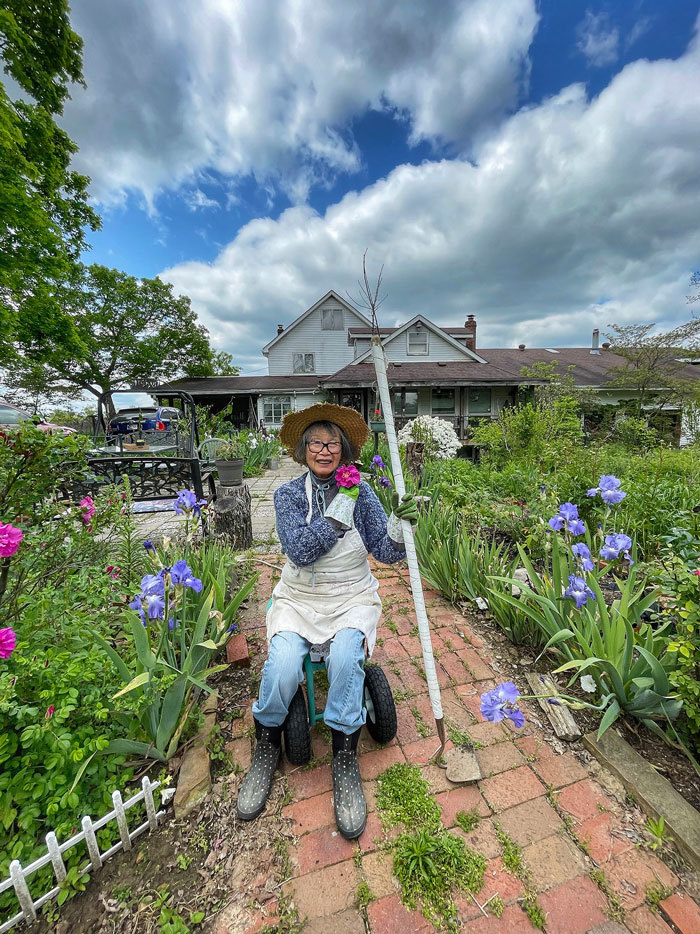 A photo of a woman in her garden by Kevin Rose Schultz
