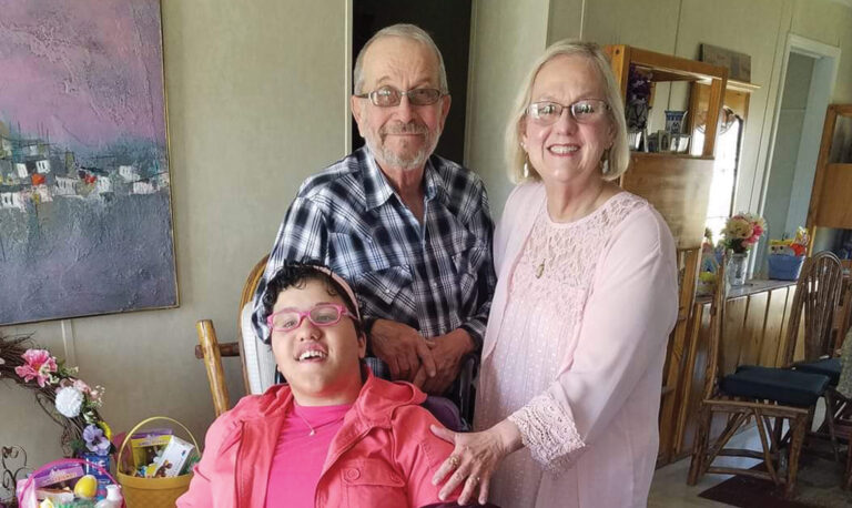 Portrait of Joan with husband and granddaughter