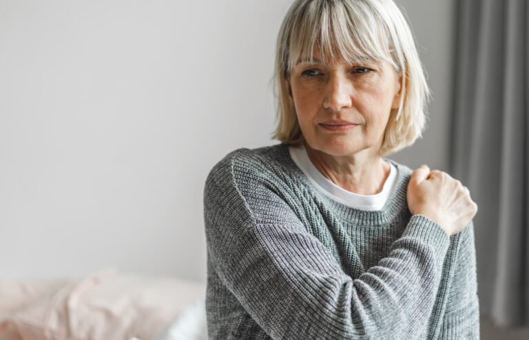 Woman with shoulder pain. Shoulder arthritis