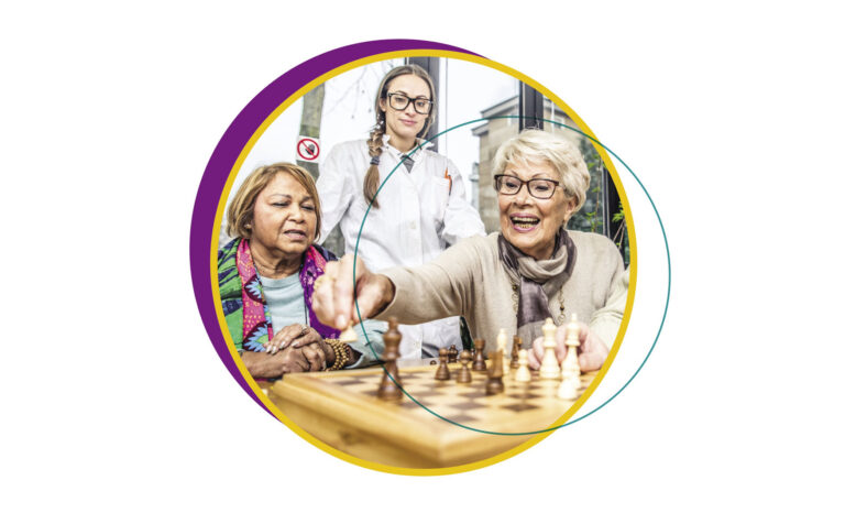 Senior women playing chess in a senior community that focuses on different aspects of wellness.