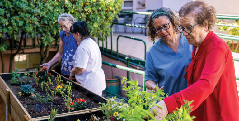 Seniors working in a stand up garden. Benefits of nature.
