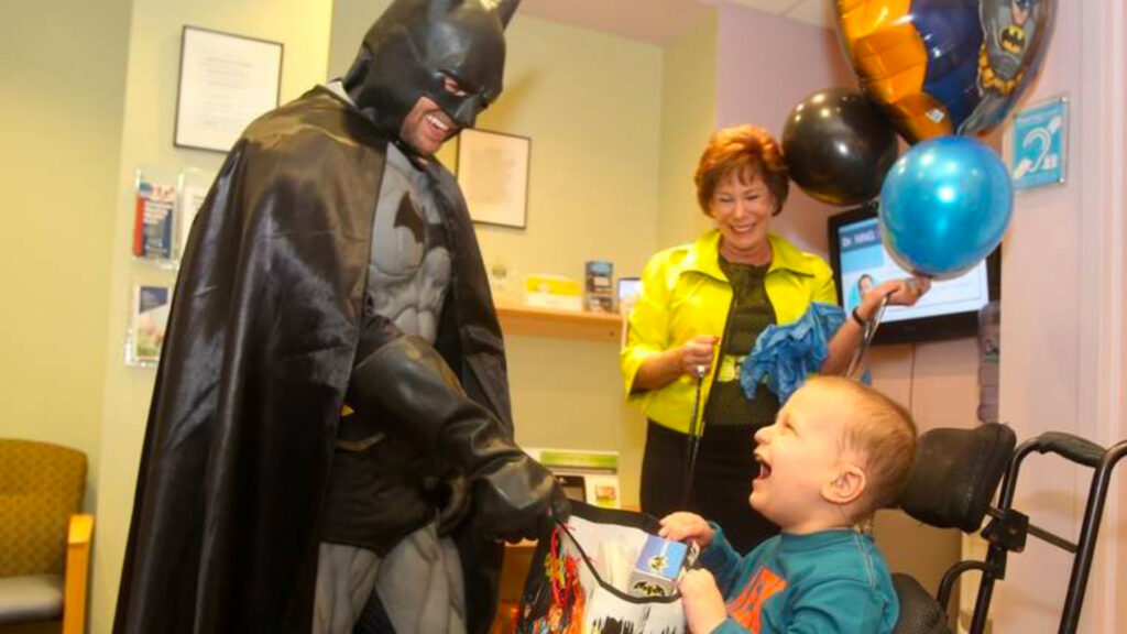 Ronna Fisher with young patient and Batman