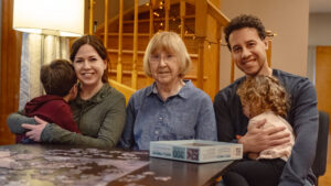 Adults from left: Emily Ellison, Barbara Friz-Ellison and Neo Ellison. A family who cares for young children and a senior adult simultaneously. Concept of sandwich caregiving.