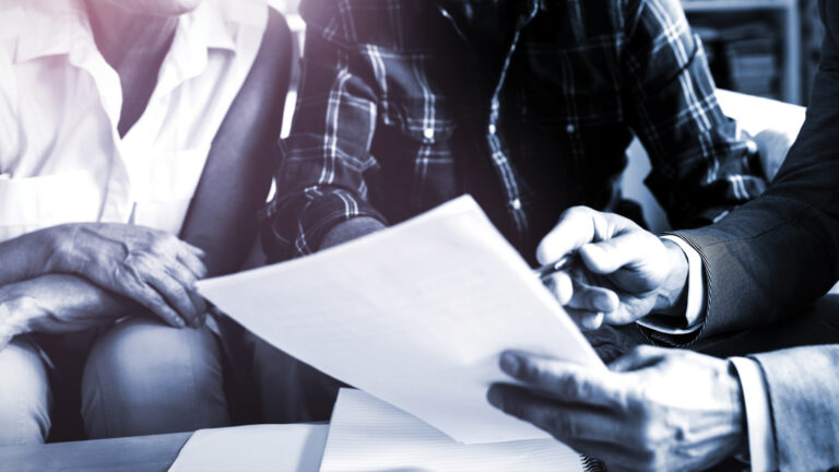 Closeup of hands working with estate planning papers