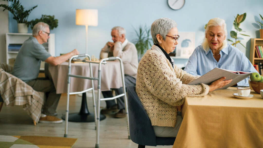 Seniors gathered in a communal area in an assisted living community.
